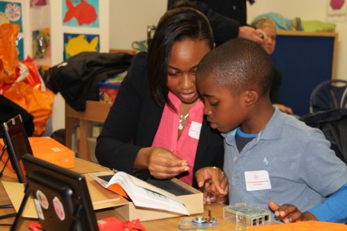 A woman and child follow instructions to build a digital making project at South London Raspberry Jam.