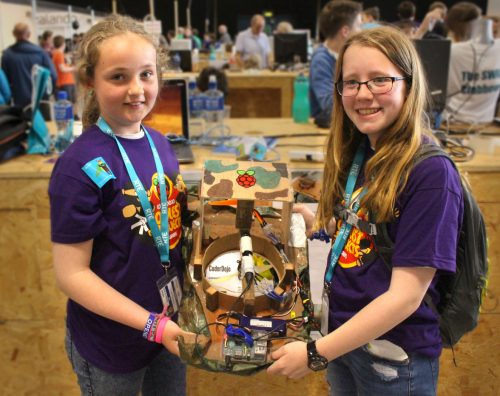 Photo: two girls wearing CoderDojo t-shirts present their Raspberry Pi-based hovercraft at CoderDojo Coolest Projects 2016