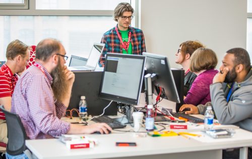 A room of educators at desktop computers.