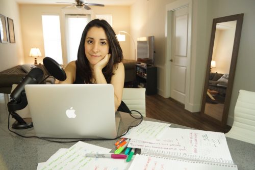 A woman sitting at a desk with a laptop and papers — Estefannie Explains it All Raspberry Pi