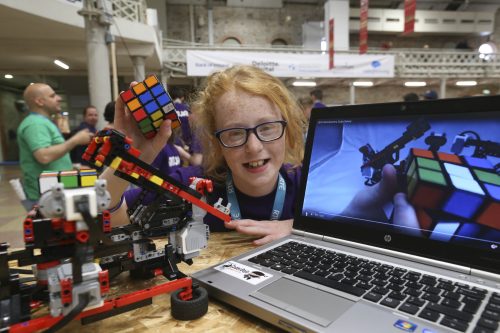 A child presenting a physical computing project