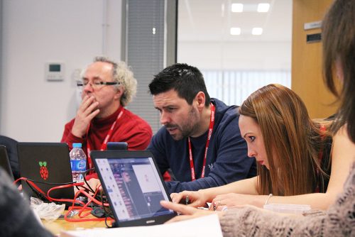 Educators sit at laptops to learn about coding and digital making.