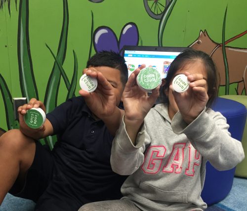 Two children holding up Code Club stickers — Boys & Girls Club