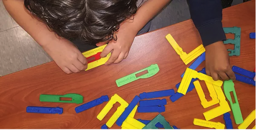 kids playing with hands-on coding blocks