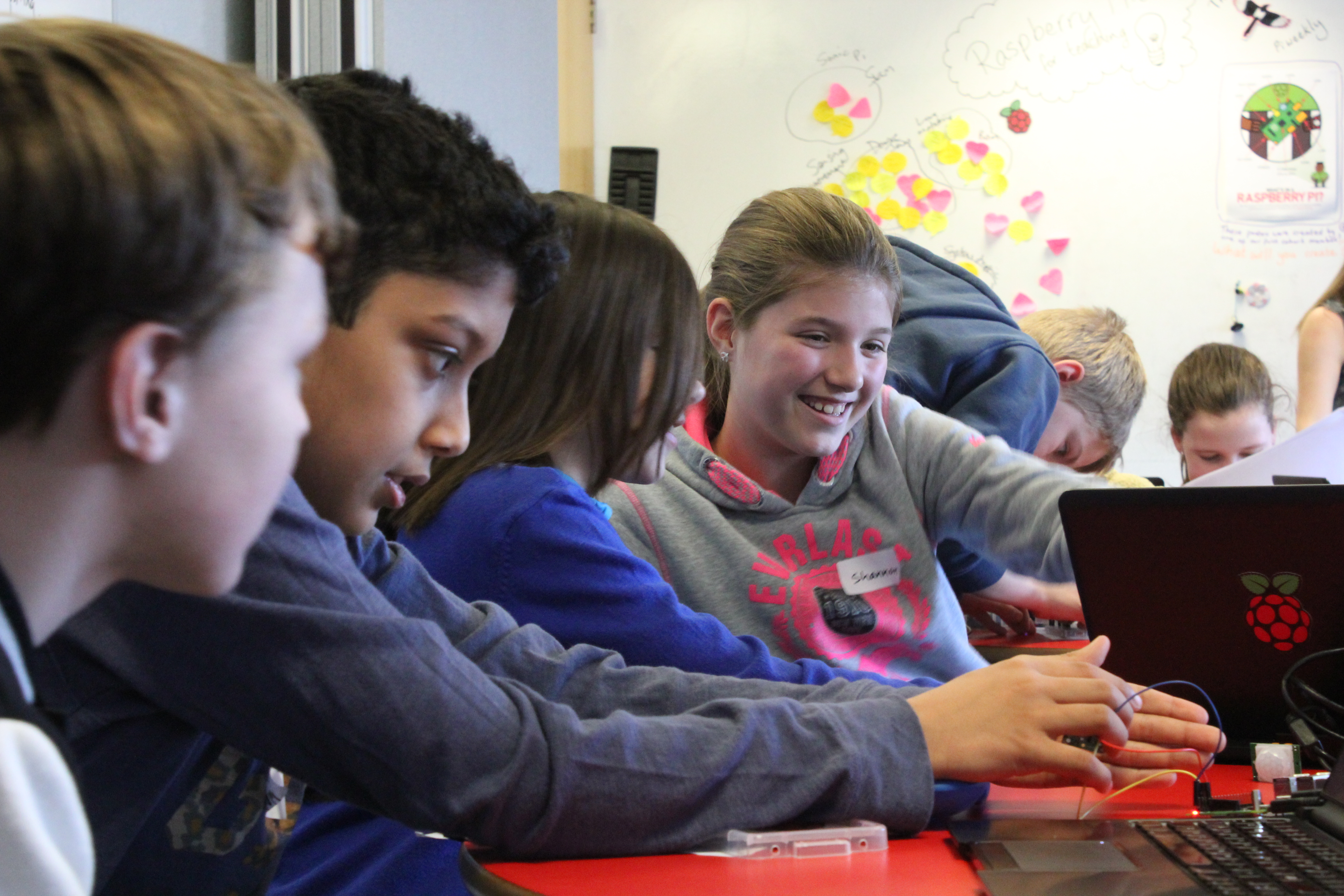 Smiling learners in a computing classroom