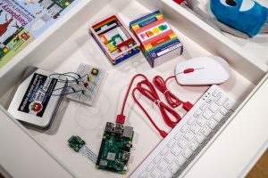 Photographs of various Raspberry Pi peripherals including a PiBow, mouse and keyboard