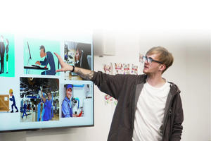 a teacher points at an interactive whiteboard