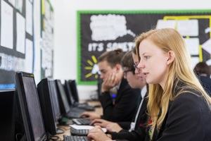 a student types on her school computer
