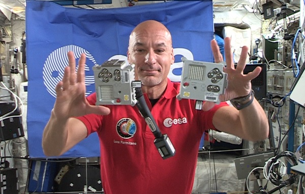 ESA Astronaut Luca Parmitiano floating aboard the ISS with two Astro Pi computers