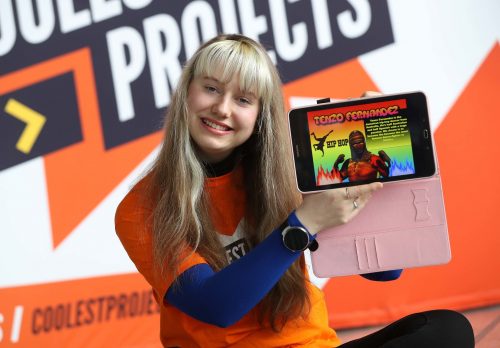 A teenage girl presenting a digital making project on a tablet