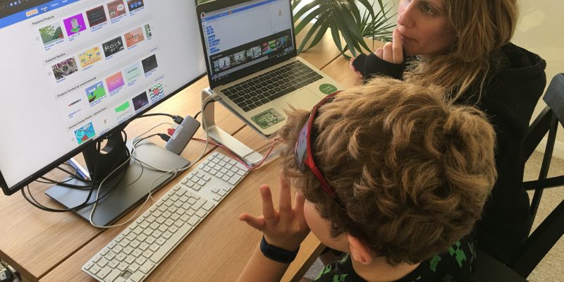 A mother and child coding at home