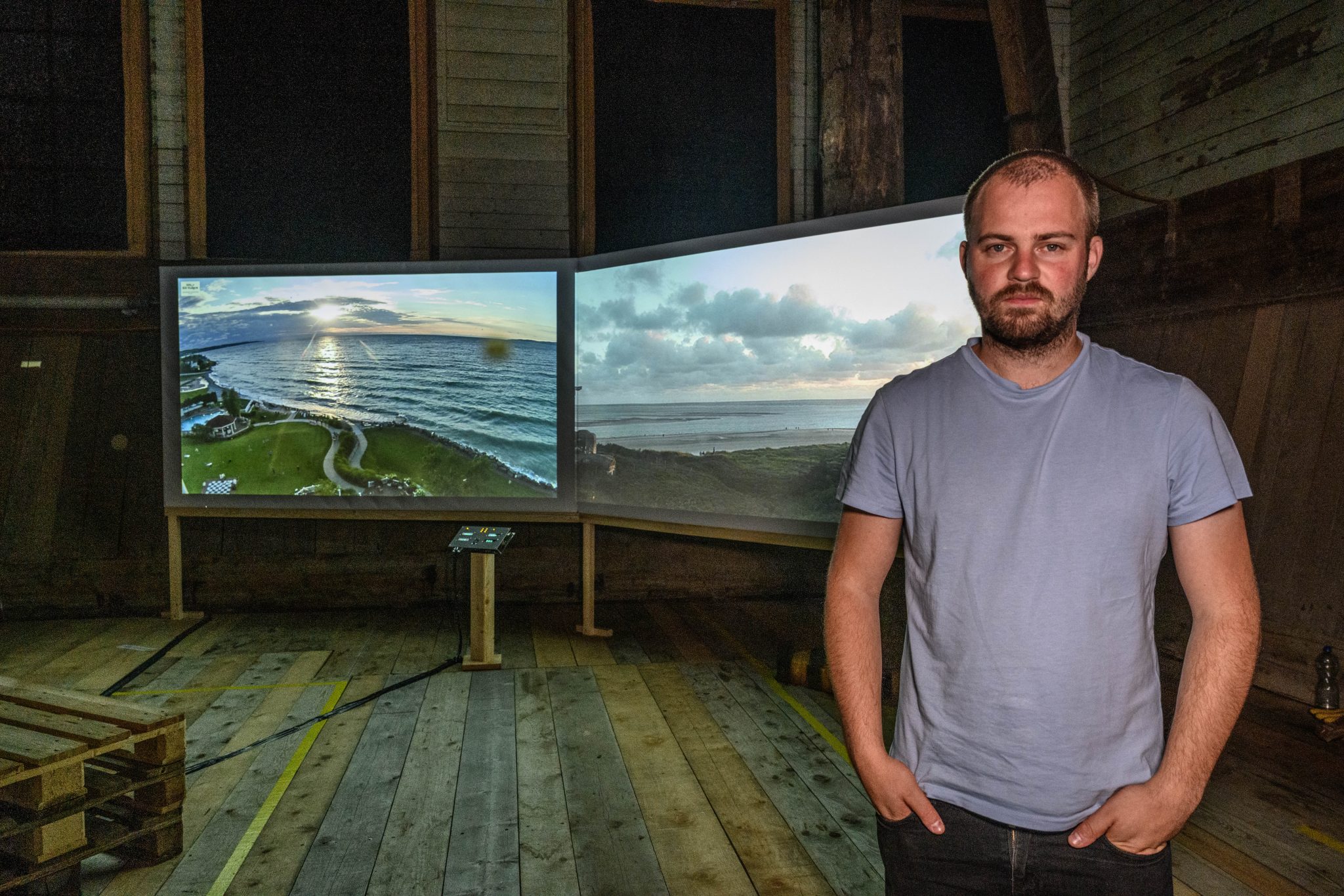 The artist stood infront of the two large display screens