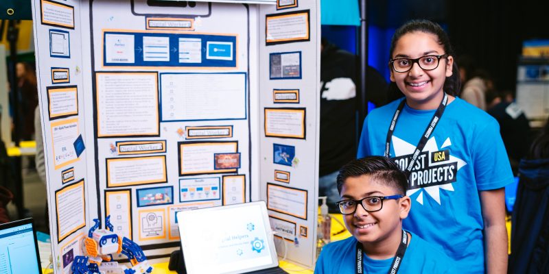 Two siblings presenting their digital making project at a Coolest Projects showcase