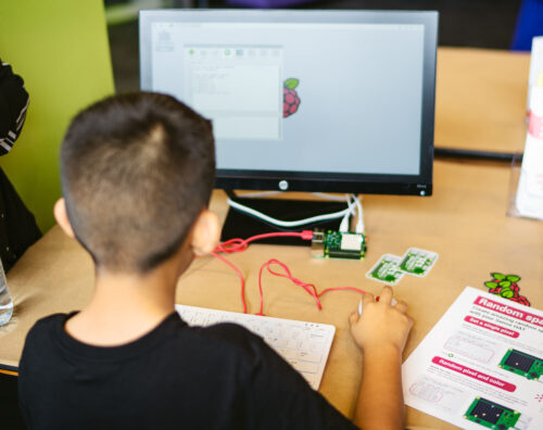 A young person using Raspberry Pi hardware and learning resources to do digital making