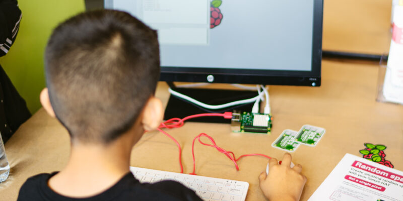 A young person using Raspberry Pi hardware and learning resources to do digital making