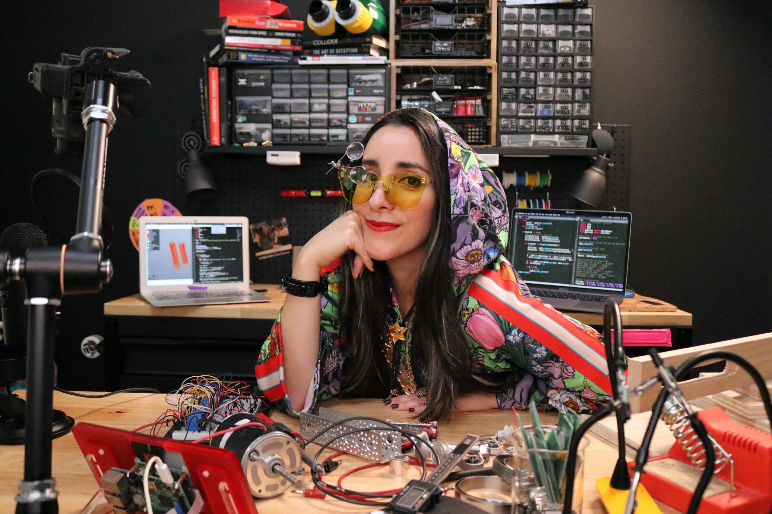 estefannie at her desk in colourful hoodie