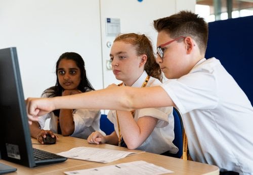 young people looking at a computer together