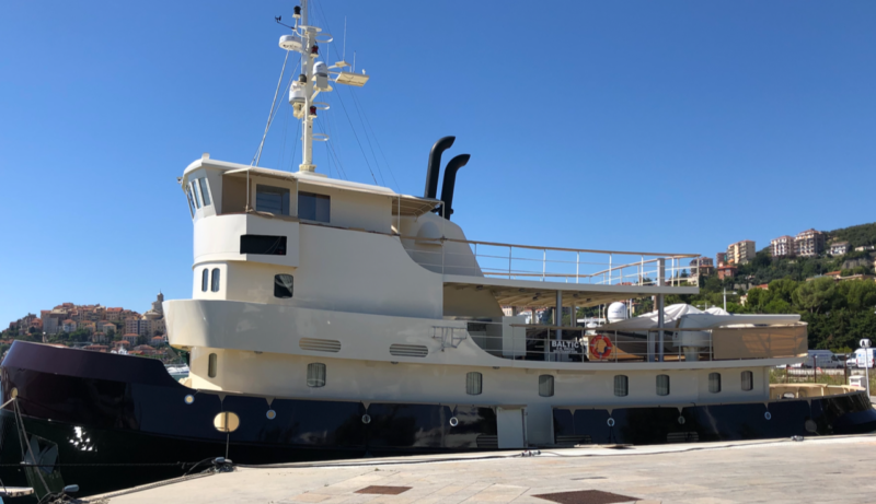 restored boat docked in sunny blue sky location