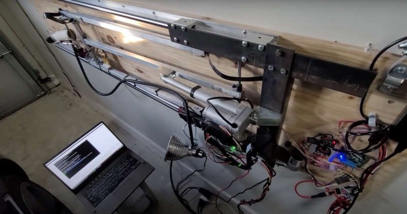 automatic tesla charger rig mounted on garage wall