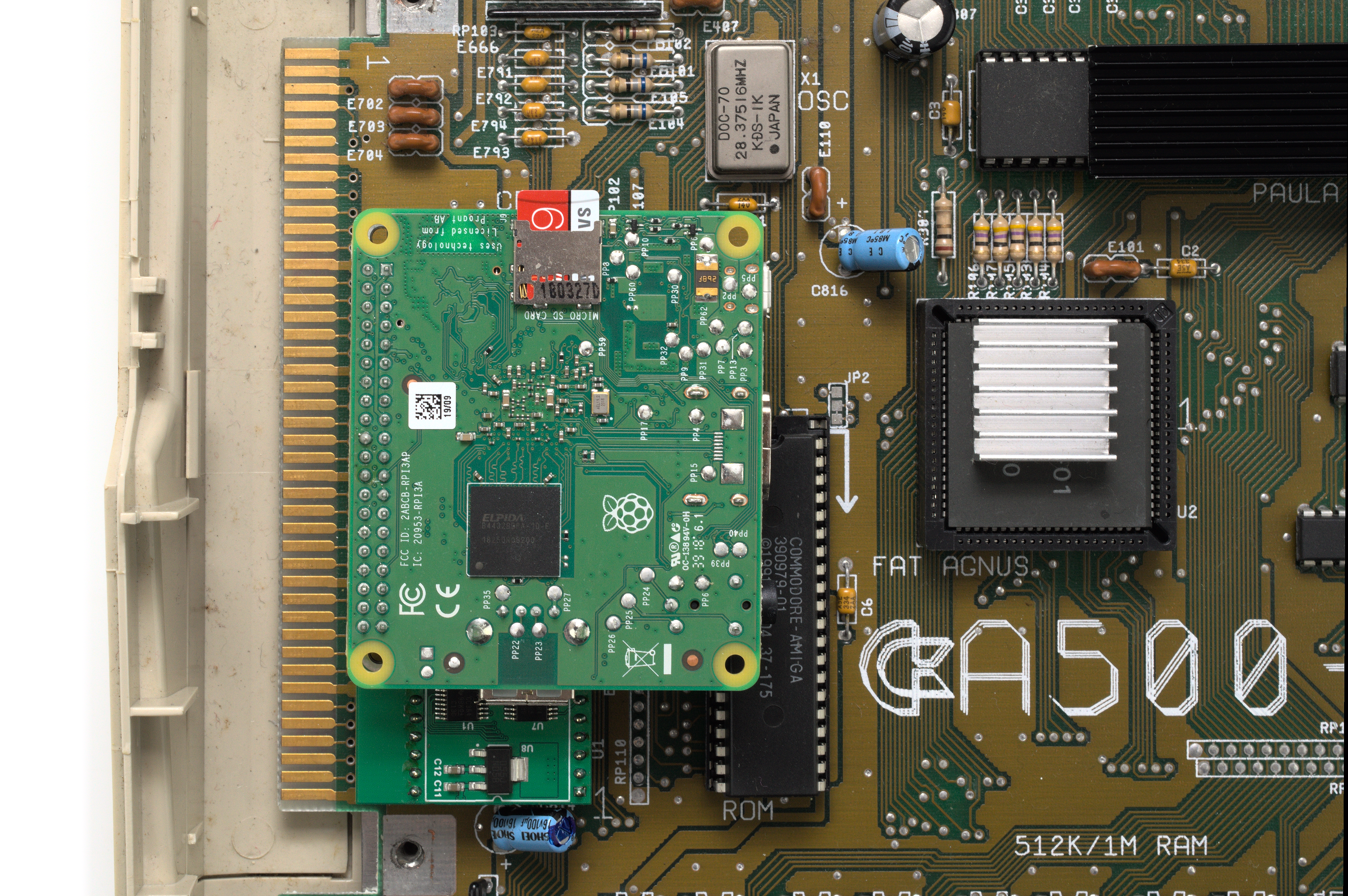 A Raspberry Pi 3 Model A+ connects to the PiStorm via its GPIO header