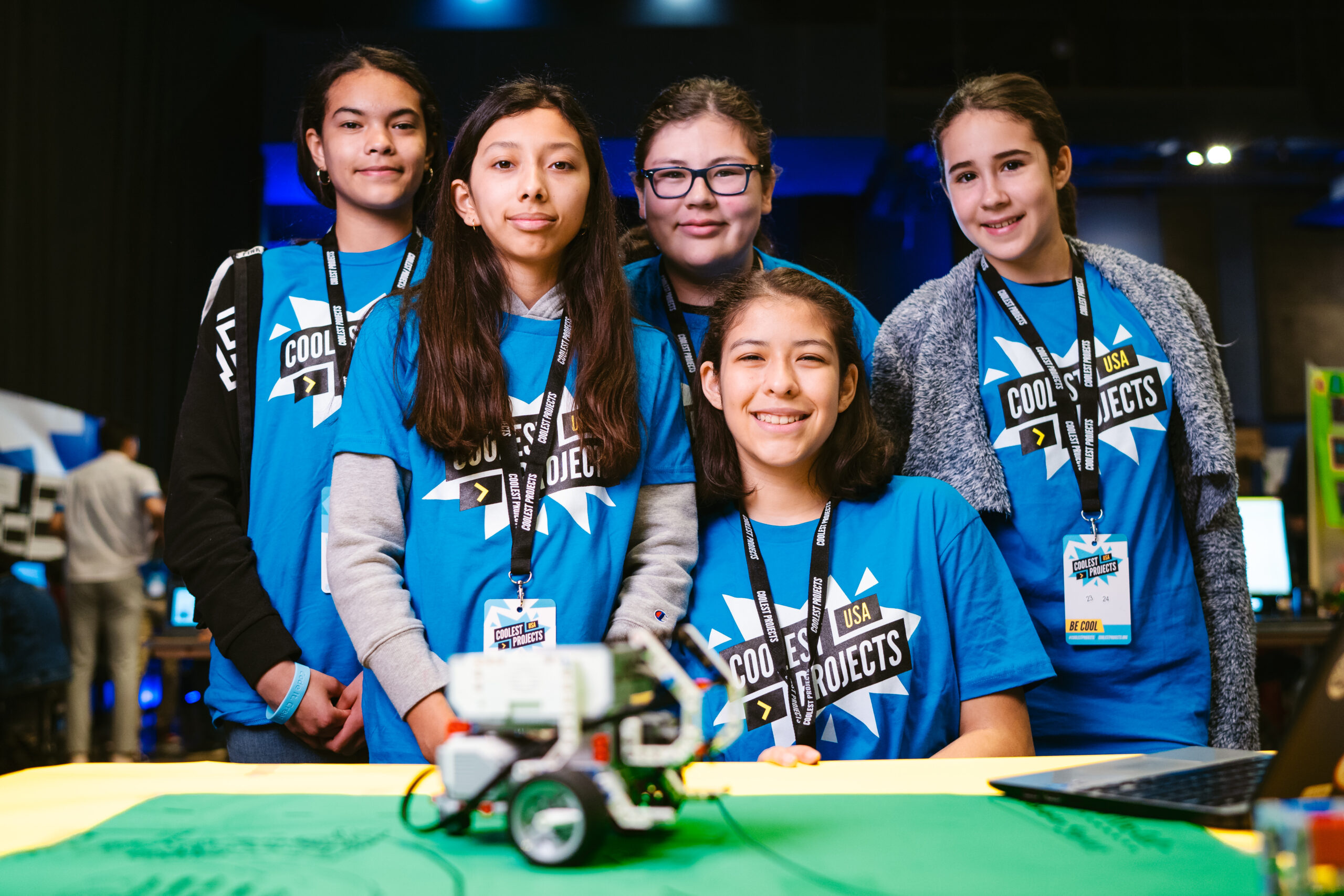 A group of young women present a robot buggy they have built.