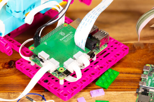 A close-up of the Raspberry Pi Build HAT on a Maker Plate and connected to electronic components.
