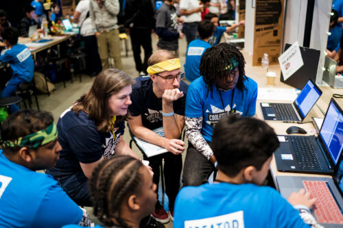 At Coolest Projects, a group of people explore a coding project.