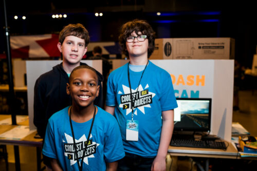 Three young tech creators show off their tech project at Coolest Projects.