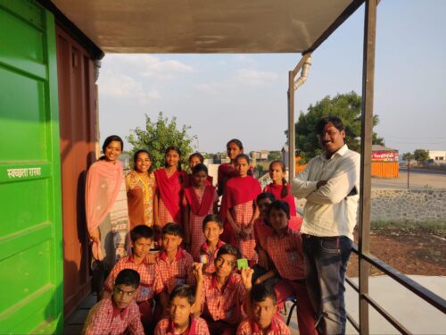 In rural India, a group of adults and children pose for the photographer.