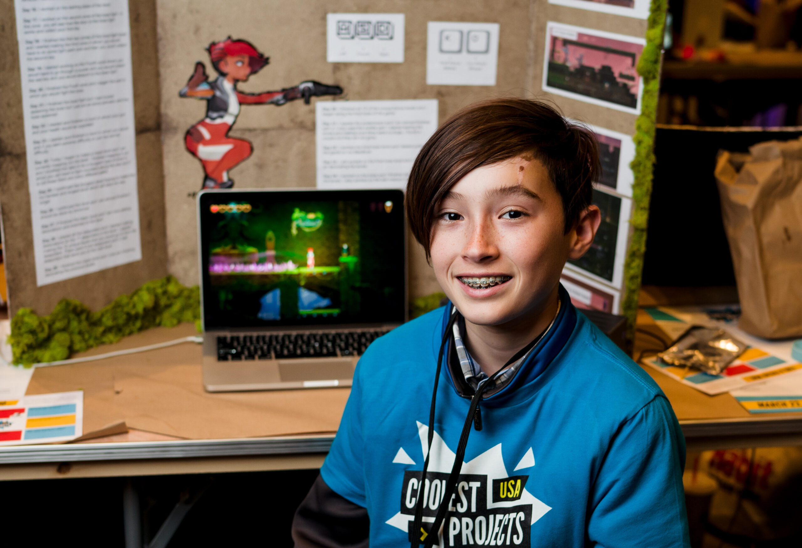A young coder shows off their tech project for Coolest Projects.