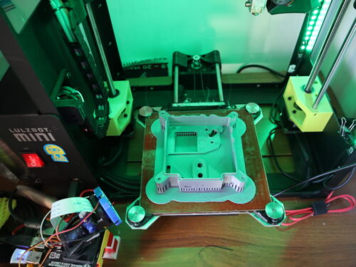 An Astro Pi case front is being printed on a 3D printer.