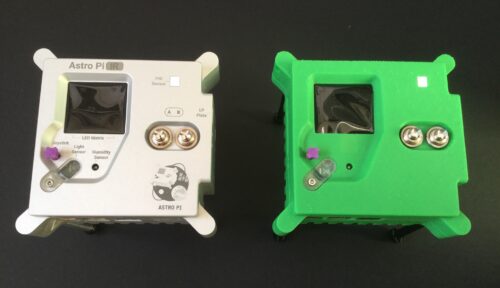 An aluminium-encased Astro Pi unit next to a 3D-printed Astro Pi unit replica.