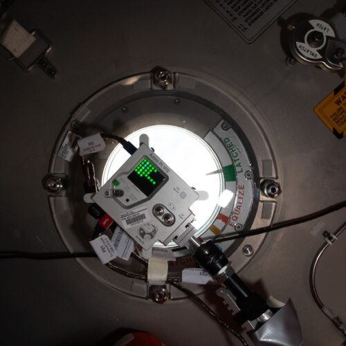 An Astro Pi unit at a window on board the International Space Station.