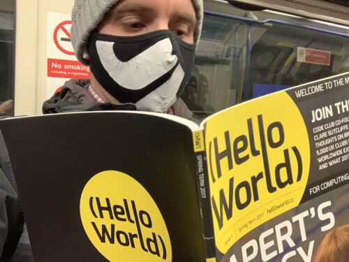 An educator reads a copy of Hello World magazine on public transport.
