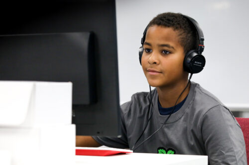 A young person codes at a Raspberry Pi computer.