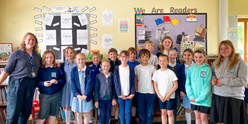 A teacher and her learners at a Code Club session.