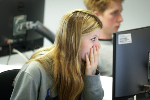 A student in a computing classroom.