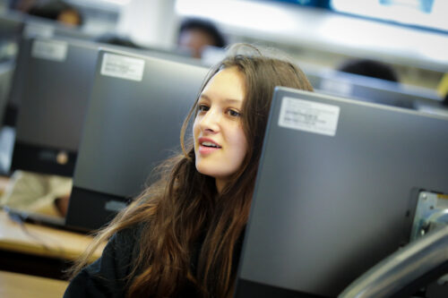 A girl in a university computing classroom.