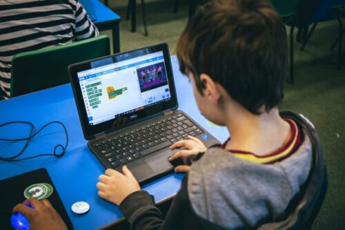 Young person using Scratch. 