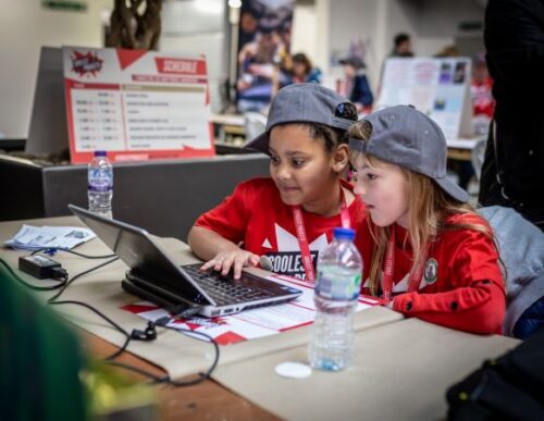 Two learners working together at a computer.