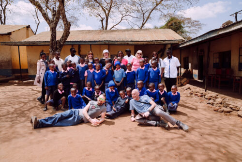 A group of learners and educators pose together in rural Kenya.