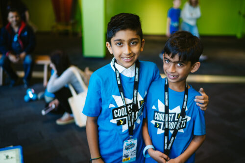 Two young people at a tech showcase event.