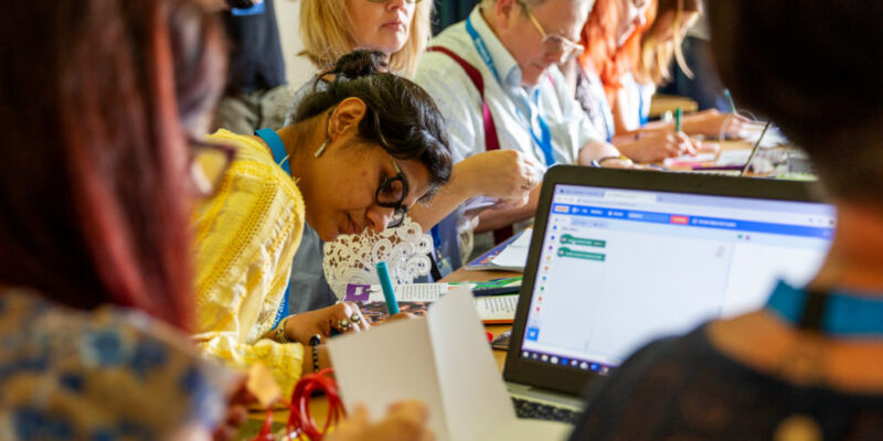 Workshop attendees at a table.