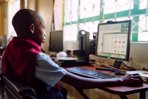 A young person uses a computer.