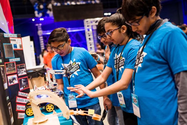 A group of young people demonstrate a project at Coolest Projects.