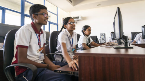 Young learners coding in a computing classroom.