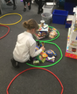 A child arranges objects to visualise data.