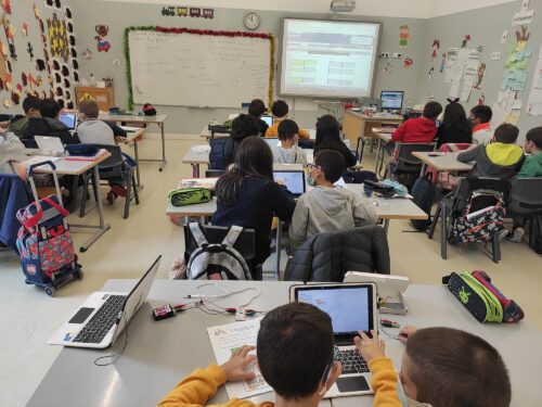 Young people at a Code Club session in a classroom.