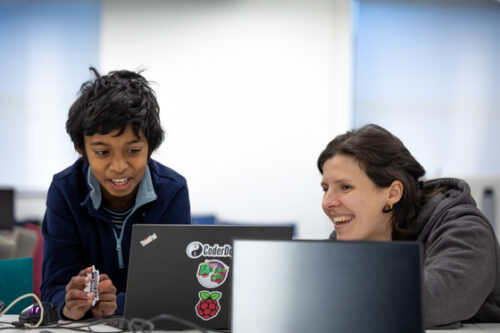A learner and a volunteer at a CoderDojo coding club.
