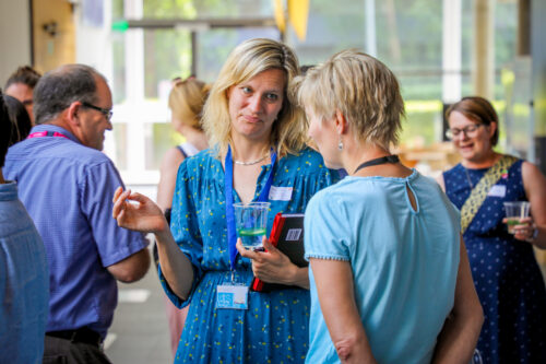 Educators and researchers mingle at a conference.